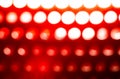 Red background with round light spots in a row
