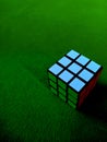 Green background with rubik object looks some mixed color combination