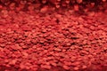 red background with shiny confetti sequins in the form of bokeh hearts. blank layout for valentine's day, greeting Royalty Free Stock Photo