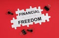 On a red background, there are puzzles with the inscription - Financial Freedom Royalty Free Stock Photo