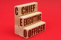 On a red background, wooden blocks with the inscription - Chief Executting Officer