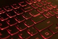 Red backlit laptop keyboard, hacking and blockchain concept