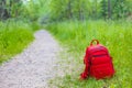 Red backpack on a forest path