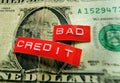 Red bad credit labels on a worn old dollar bill Royalty Free Stock Photo
