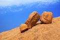 Red bald granite peak, blue sky, white cloud background, three round ancient orange stones, natural yellow rock, Swakopmund