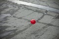 Red ball on background of asphalt. Abstract art. Sphere made of plastic Royalty Free Stock Photo
