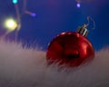 Red Ball Christmas Ornament on a Blue Background. Christmas Light Bulbs Royalty Free Stock Photo