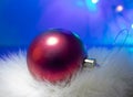 Red Ball Christmas Ornament on a Blue Background. Christmas Light Bulbs Royalty Free Stock Photo