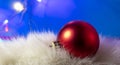 Red Ball Christmas Ornament on a Blue Background. Christmas Light Bulbs Royalty Free Stock Photo