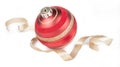 Red ball Christmas ornament, gold ribbon on white Royalty Free Stock Photo