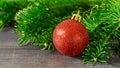 Red ball, Christmas toy, Christmas tree branch on a wooden Royalty Free Stock Photo