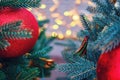 Red ball on the Christmas tree and bokeh background of garland lights, copy space Royalty Free Stock Photo