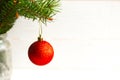 Red ball on Christmas tree branch. Royalty Free Stock Photo