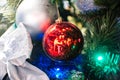 Red ball on Christmas tree closeup branches and reflection