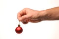 Red ball Christmas tree decoration in hand Royalty Free Stock Photo