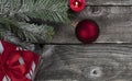 Red ball ornament plus decorations on vintage wooden planks for a merry Christmas or happy New Year holiday celebration concept Royalty Free Stock Photo