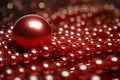 a red ball sits on top of a pile of red pearls