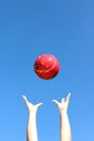 Red ball thrown in the air Royalty Free Stock Photo