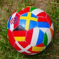 Red ball with various international flags on it with an interesting design