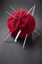 Red ball of wool and knitting needles Royalty Free Stock Photo