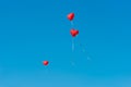 Red ballons with the messages in the blue sky Royalty Free Stock Photo