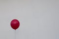 Red balloon against a white wall. Depression and Anxiety