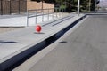 Red balloon hanging from storm drain