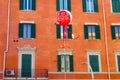 Red balloon with orange building on background