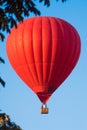 Red balloon in the sky. Aerostat. People in the basket. Fun. Summer entertainment. Romantic adventures