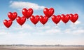 Red balloons in the blue sky. Horizontal banner. Valentine's day background with heart-shaped balloons in bright blue sky Royalty Free Stock Photo