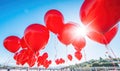 Red balloons in the blue sky. Horizontal banner. Valentine's day background with heart-shaped balloons in bright blue sky Royalty Free Stock Photo