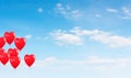 Red balloons in the blue sky. Horizontal banner. Valentine's day background with heart-shaped balloons in bright blue sky Royalty Free Stock Photo