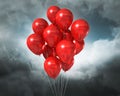 Red balloons on a cloudy dramatic sky Royalty Free Stock Photo