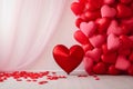 Red balloons in the shape of hearts around scattered rose petals transparent curtain in the background.Valentine\'s Day banne Royalty Free Stock Photo