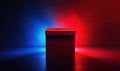 Red ballot box illuminated by blue and red lights representing political voting Royalty Free Stock Photo