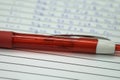 Red ballpen on white notebook
