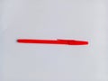Red ballpoint pen on white background. One red pen for writing. Royalty Free Stock Photo