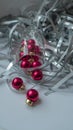 A dynamic composition for a festive mood, consisting of bright red Christmas balls and a transparent sparkling wine glass