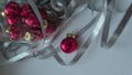 A dynamic composition for a festive mood, consisting of bright red Christmas balls and a transparent sparkling wine glass