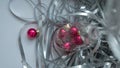 A dynamic composition for a festive mood, consisting of bright red Christmas balls and a transparent sparkling wine glass