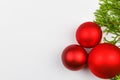 Red balls on green branches, white background. Gift wrapping with a red bow on a white background. View from above. Place for Royalty Free Stock Photo