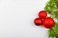 Red balls on green branches, white background. Gift wrapping with a red bow on a white background. View from above. Place for Royalty Free Stock Photo