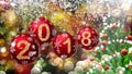 Red balls with numbers 2018 hanging on the background of a bokeh and a rotating Christmas tree. Royalty Free Stock Photo
