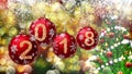 Red balls with numbers 2018 hanging on the background of a bokeh and a rotating Christmas tree. Royalty Free Stock Photo