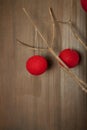 Red balls of string on branch on neutral wall