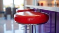Red bar stool with chrome legs in a modern kitchen setting. Royalty Free Stock Photo
