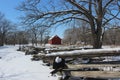 Red Barn behind Split Rail Zig Zag Fence in Winter Royalty Free Stock Photo