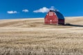 Red barn blue sky and wheat stuble field Royalty Free Stock Photo