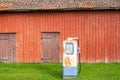 Red barn in the country with an old rusty petrol pump Royalty Free Stock Photo