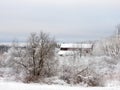 Red barn covered in snow in NYS FingerLakes overlooking CayugaLake Royalty Free Stock Photo